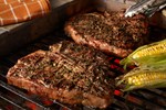 grilled-porterhouse-steaks-with-garlic-herb-peppercorn-crust-with-corn-horizontal