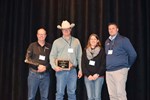 Kennedy Cattle Company Steve Rehder, IBIC Chair; Zak and Emily Kennedy, 2018 Iowa Feedlot Award; and Rusty Gibbs, Director of Industry Relations IBIC / Iowa BQA Coordinator.